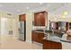 Stylish kitchen featuring stainless appliances, granite counters, and seamless transition to the living area at 3245 S Atlantic Ave # 208, Daytona Beach, FL 32118
