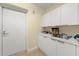 Laundry room offering ample counter space and cabinet storage at 3245 S Atlantic Ave # 208, Daytona Beach, FL 32118