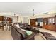 Relaxing living room showcases a comfortable leather sectional, media center, and seamless flow to the kitchen at 3245 S Atlantic Ave # 208, Daytona Beach, FL 32118