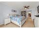 Bright main bedroom features a decorative ceiling fan, built-in bookcase, and tiled floor at 3245 S Atlantic Ave # 208, Daytona Beach, FL 32118