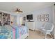 Spacious main bedroom with ceiling fan, tiled floor, dresser, and seating area at 3245 S Atlantic Ave # 208, Daytona Beach, FL 32118