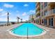 Stunning pool with ocean view, brick pavers, and lounge seating at 3245 S Atlantic Ave # 208, Daytona Beach, FL 32118