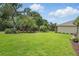 Serene backyard with lush tropical landscaping and a green lawn with irrigation system at 3378 Leonardo Ln, New Smyrna Beach, FL 32168