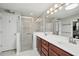 Bathroom featuring double sink vanity, updated fixtures, glass-enclosed walk-in shower, and ceramic tile at 3378 Leonardo Ln, New Smyrna Beach, FL 32168