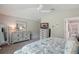 Cozy bedroom featuring a neutral color scheme, ceiling fan, dressers, and carpeted floors at 3378 Leonardo Ln, New Smyrna Beach, FL 32168