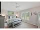 Bright bedroom with a large window, comfortable queen bed, ceiling fan, and carpeted floors at 3378 Leonardo Ln, New Smyrna Beach, FL 32168