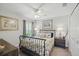 Bedroom featuring a metal frame bed, carpeted floors, ceiling fan, and two bedside tables with lamps at 3378 Leonardo Ln, New Smyrna Beach, FL 32168