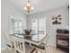 Traditional dining room features hardwood table, cushioned chairs, and elegant chandelier lighting at 3378 Leonardo Ln, New Smyrna Beach, FL 32168