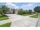 Charming single-story home featuring a well-manicured lawn and tropical landscaping, enhancing its curb appeal at 3378 Leonardo Ln, New Smyrna Beach, FL 32168