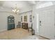 Inviting foyer with a high ceiling, an elegant chandelier, and tiled flooring at 3378 Leonardo Ln, New Smyrna Beach, FL 32168