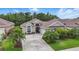 Inviting single-story home with a well-manicured lawn, mature landscaping, and a concrete driveway at 3378 Leonardo Ln, New Smyrna Beach, FL 32168