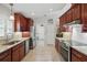 Well-equipped kitchen features granite counters, rich cabinetry, and tile flooring at 3378 Leonardo Ln, New Smyrna Beach, FL 32168