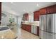 Open kitchen with stainless steel appliances, granite countertops, and an adjacent breakfast nook at 3378 Leonardo Ln, New Smyrna Beach, FL 32168