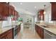 Updated kitchen featuring stainless appliances, granite counters, and a view of the backyard at 3378 Leonardo Ln, New Smyrna Beach, FL 32168