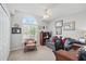 Bright office space featuring a large window, comfortable sofa, and a ceiling fan at 3378 Leonardo Ln, New Smyrna Beach, FL 32168