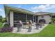 Screened-in patio with a seating area, grill, and a well-maintained paver patio at 3378 Leonardo Ln, New Smyrna Beach, FL 32168