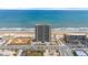 Stunning aerial view of a high rise beachfront condominium building with ocean views and a lively beach at 3425 S Atlantic Ave # 902, Daytona Beach, FL 32118