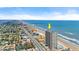 An aerial view of the oceanfront highrise with surrounding areas at 3425 S Atlantic Ave # 902, Daytona Beach, FL 32118
