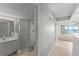 Bathroom featuring a vanity with a mirror, bright lights, and a walk-in shower with glass door at 3425 S Atlantic Ave # 902, Daytona Beach, FL 32118