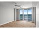 Bright bedroom with ceiling fan, large glass doors with ocean view, and carpeted floor at 3425 S Atlantic Ave # 902, Daytona Beach, FL 32118