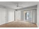 Bedroom with carpet, bright walls, ceiling fan, and sliding glass door leading to the balcony at 3425 S Atlantic Ave # 902, Daytona Beach, FL 32118