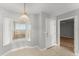 Cozy dining area with windows, view, pendant lighting, and an entry door to the unit at 3425 S Atlantic Ave # 902, Daytona Beach, FL 32118