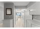 Modern kitchen area with white cabinets, and appliances, and an open view into the living area at 3425 S Atlantic Ave # 902, Daytona Beach, FL 32118