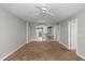 Spacious living room featuring carpet flooring, a ceiling fan, and an open floor plan at 3425 S Atlantic Ave # 902, Daytona Beach, FL 32118