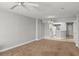 Open concept living room, seamless transition to the kitchen, ceiling fan, carpet flooring and bright light at 3425 S Atlantic Ave # 902, Daytona Beach, FL 32118