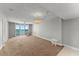 Bright and airy living room featuring a chandelier and sliding glass doors to the balcony at 3425 S Atlantic Ave # 902, Daytona Beach, FL 32118