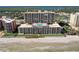 Stunning aerial view showcases a high-rise condo building with a rooftop pool and beach access at 4139 S Atlantic Ave # A302, New Smyrna Beach, FL 32169