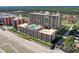 Expansive aerial view showcasing a high-rise condo building with a rooftop pool and beach access at 4139 S Atlantic Ave # A302, New Smyrna Beach, FL 32169