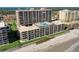 Wide aerial perspective showcases a high-rise condo building with rooftop pool and beach access at 4139 S Atlantic Ave # A302, New Smyrna Beach, FL 32169