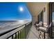 Spacious balcony with seating offering stunning views of the ocean and a beautiful sunny day at 4139 S Atlantic Ave # A302, New Smyrna Beach, FL 32169