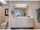 Neat bathroom featuring a large mirror, vanity, and ample storage space with modern fixtures at 4139 S Atlantic Ave # A302, New Smyrna Beach, FL 32169