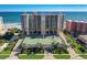Stunning oceanfront condo building featuring a tennis court, lush landscaping, and breathtaking ocean views at 4139 S Atlantic Ave # A302, New Smyrna Beach, FL 32169