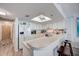 Modern kitchen with breakfast bar, white cabinetry, and updated appliances, perfect for entertaining at 4139 S Atlantic Ave # A302, New Smyrna Beach, FL 32169