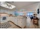 Bright kitchen showcasing white appliances and cabinetry, with seamless transition to the dining and living areas at 4139 S Atlantic Ave # A302, New Smyrna Beach, FL 32169