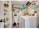Well-organized laundry room with washer, dryer, and ample shelving for storage at 4139 S Atlantic Ave # A302, New Smyrna Beach, FL 32169