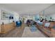 Bright living room featuring comfortable seating and an open layout to the dining room and kitchen area at 4139 S Atlantic Ave # A302, New Smyrna Beach, FL 32169