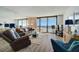 Bright living room featuring comfortable seating, stylish decor, and ocean view access to the balcony at 4139 S Atlantic Ave # A302, New Smyrna Beach, FL 32169
