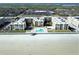 An aerial view of the Castle Reef Condominiums and the nearby beach, and community pool at 4175 S Atlantic Ave # 2280, New Smyrna Beach, FL 32169