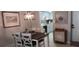 Open dining room with a dark wood table, seating for four, and easy access to the updated kitchen at 4175 S Atlantic Ave # 2280, New Smyrna Beach, FL 32169