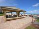 Community pavilion with tables and benches for socializing overlooking shuffleboard courts and the ocean at 4175 S Atlantic Ave # 2280, New Smyrna Beach, FL 32169