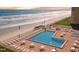 Beachfront pool deck with ocean views, lounge chairs, and tables providing a relaxing retreat steps from the beach at 4175 S Atlantic Ave # 2280, New Smyrna Beach, FL 32169