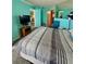 Open bedroom offers furniture, bright color scheme, and access to other rooms at 421 S Atlantic Ave # 407, New Smyrna Beach, FL 32169