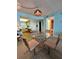 Cozy dining area featuring a glass table, four chairs, and unique lighting at 421 S Atlantic Ave # 407, New Smyrna Beach, FL 32169