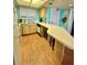 Efficient kitchen featuring a breakfast bar with seating and linoleum floors at 421 S Atlantic Ave # 407, New Smyrna Beach, FL 32169