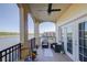 Scenic balcony with lake views, comfortable seating and elegant architectural arches at 424 Luna Bella Ln # 316, New Smyrna Beach, FL 32168