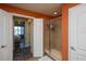 Bathroom showcasing an updated glass-door shower and view into a bedroom at 424 Luna Bella Ln # 316, New Smyrna Beach, FL 32168